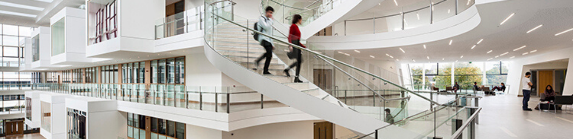 Two students going down the spiral staircase in the UCD O'Brien Centre for Science