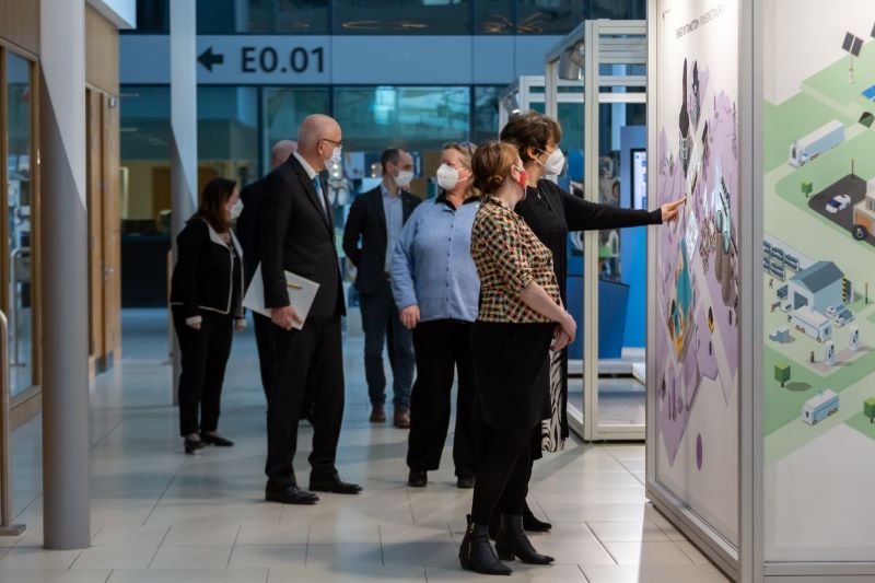 His Excellency Ambassador Cord Meier-Clodt (German Ambassador to Ireland) and UCD guests view the Energy in Transition exhibition.