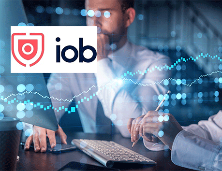iob logo with man looking at computer