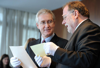 UCD President, Dr Hugh Brady, and RTE Director General, Cathal Goan, examine written correspondence between Samuel Beckett and Hilton Edwards in 1961. Edwards, then head of drama at Radio Éireann, invited Beckett to write for RTÉ television. Beckett turned down the invitation because he was “très unfamiliar with the television and its possibilities”.