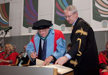 Daniel Browne who was awarded an honorary doctorate by UCD, signs the register