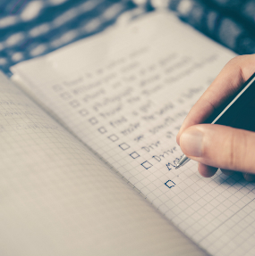 pen writing checklist in notebook