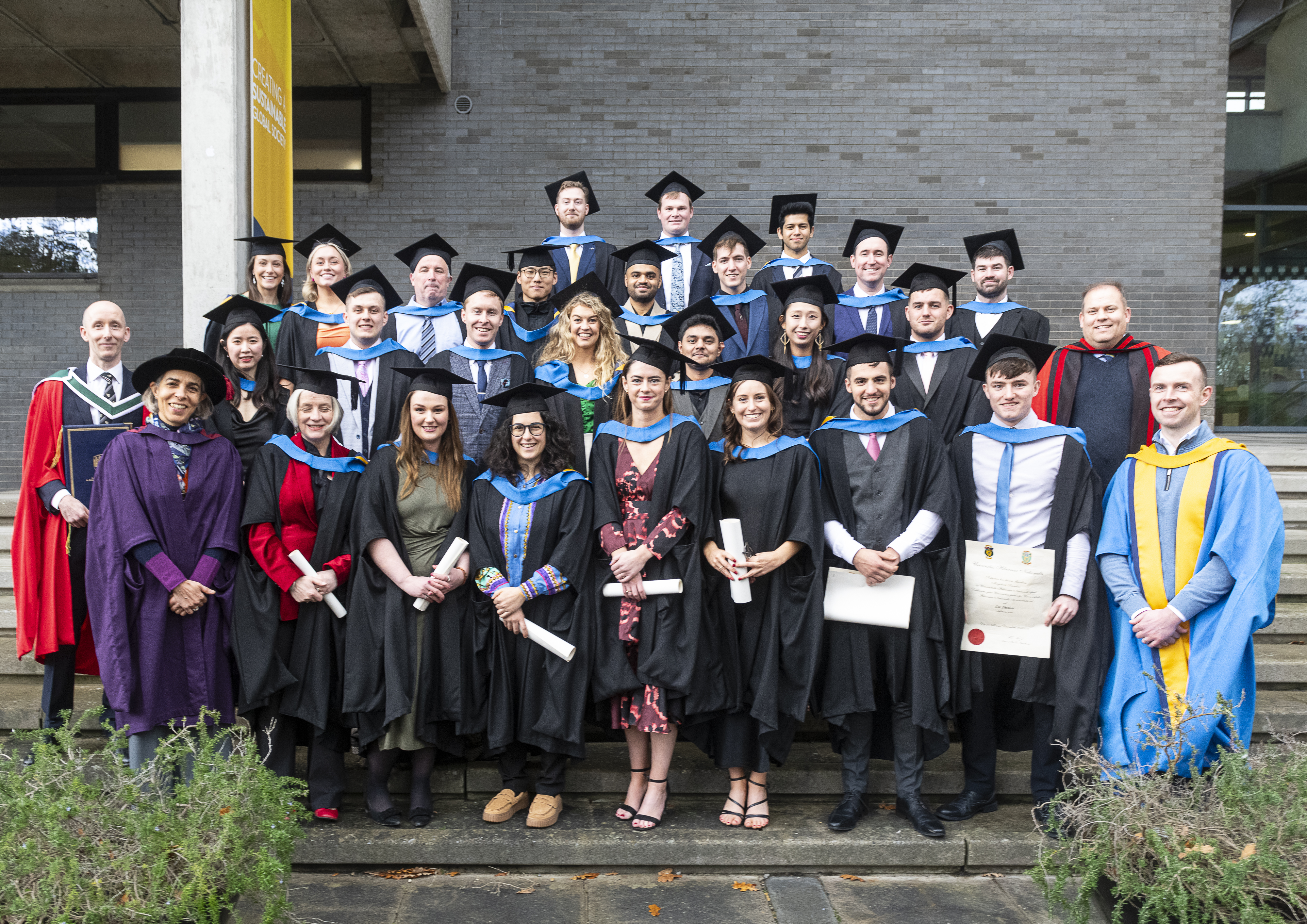 Students in academic dress after their conferring ceremony