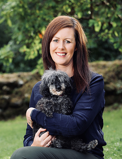 Dr Nicola Fletcher holding her dog, Noodle the poodle
