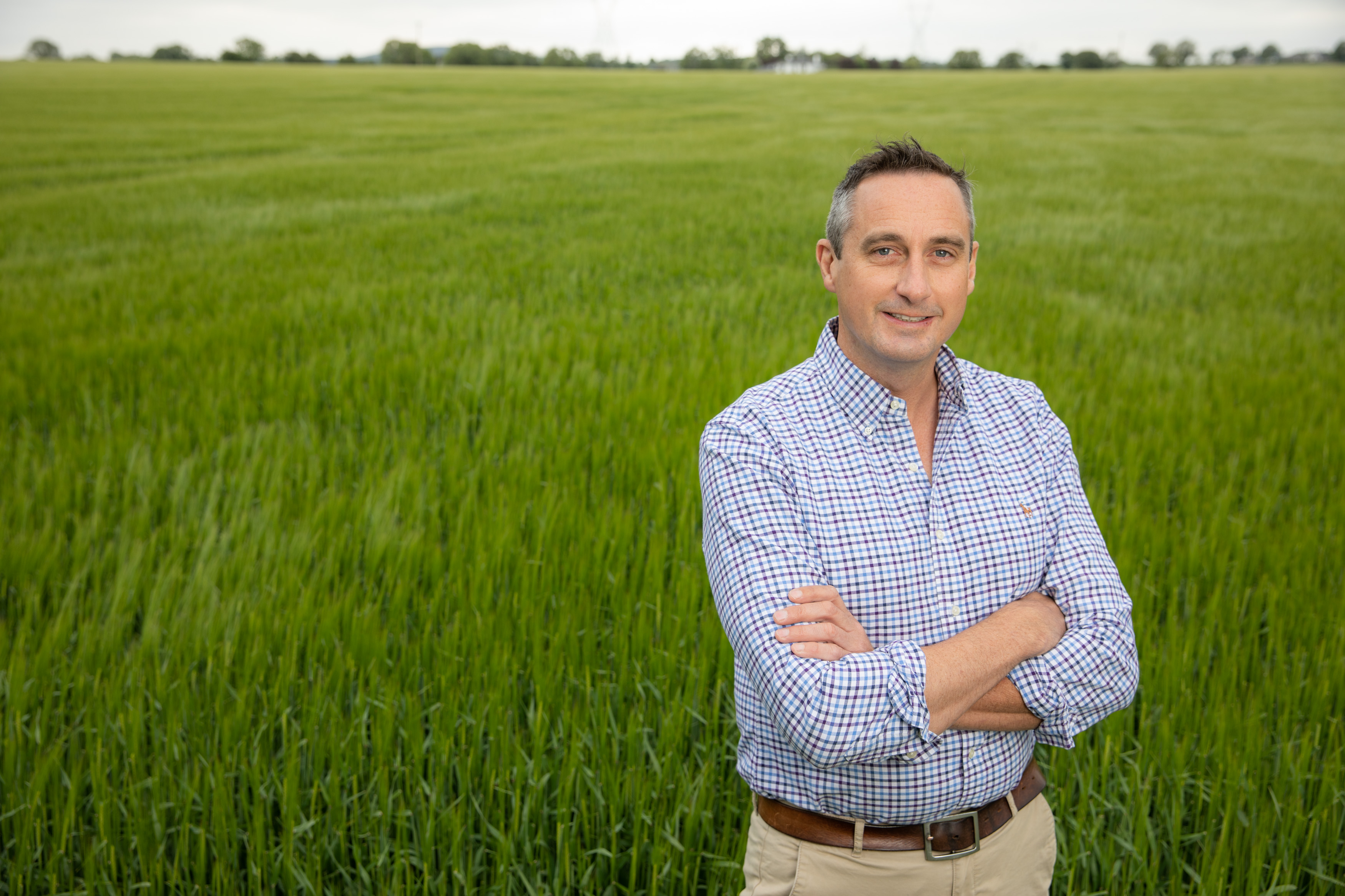 Eoin Lowry Alum 2001 is standing in a green field