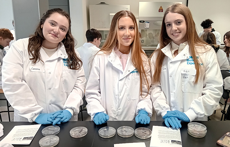 Curiosity programme students in lab coats.