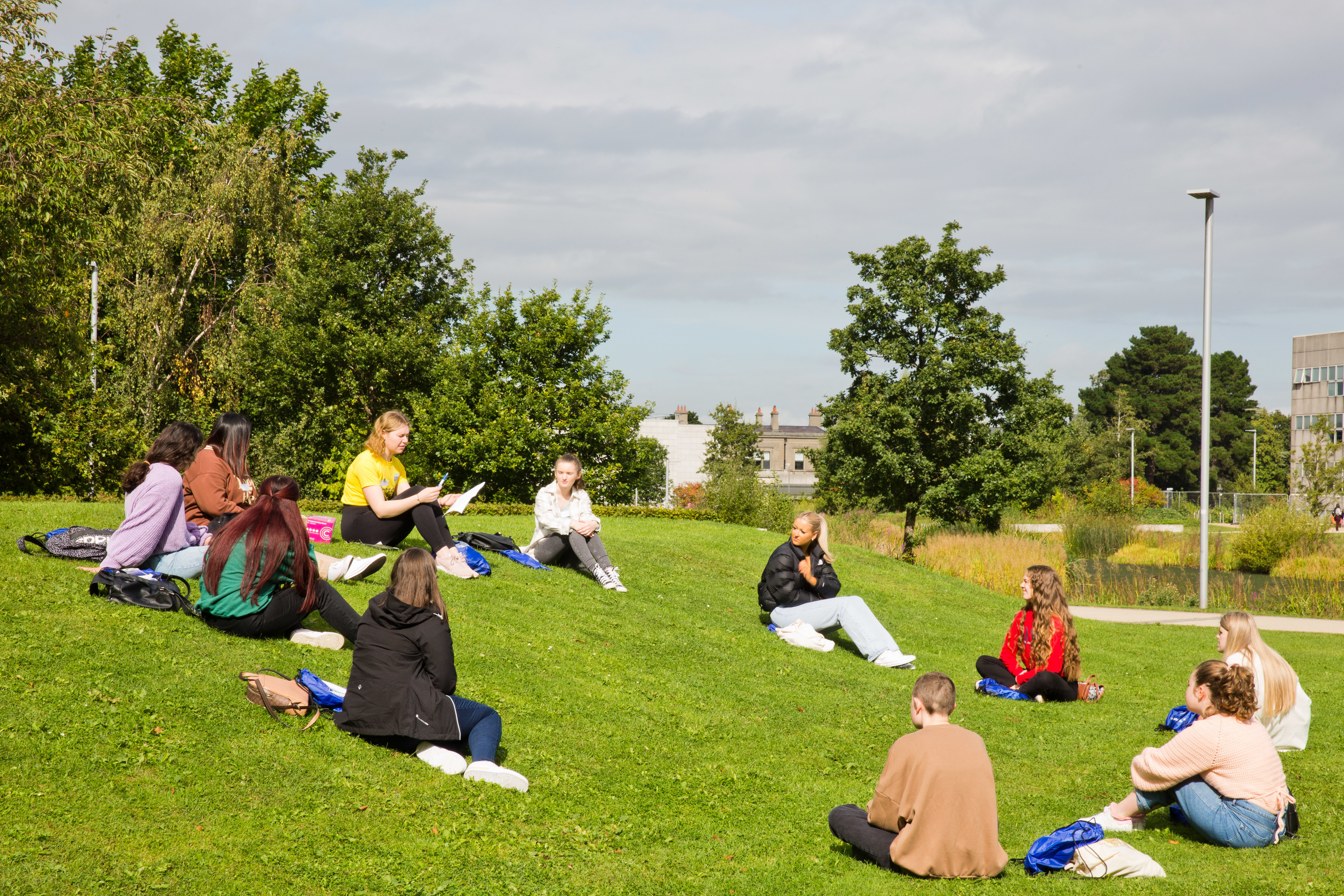 Students sitting on grass chatting