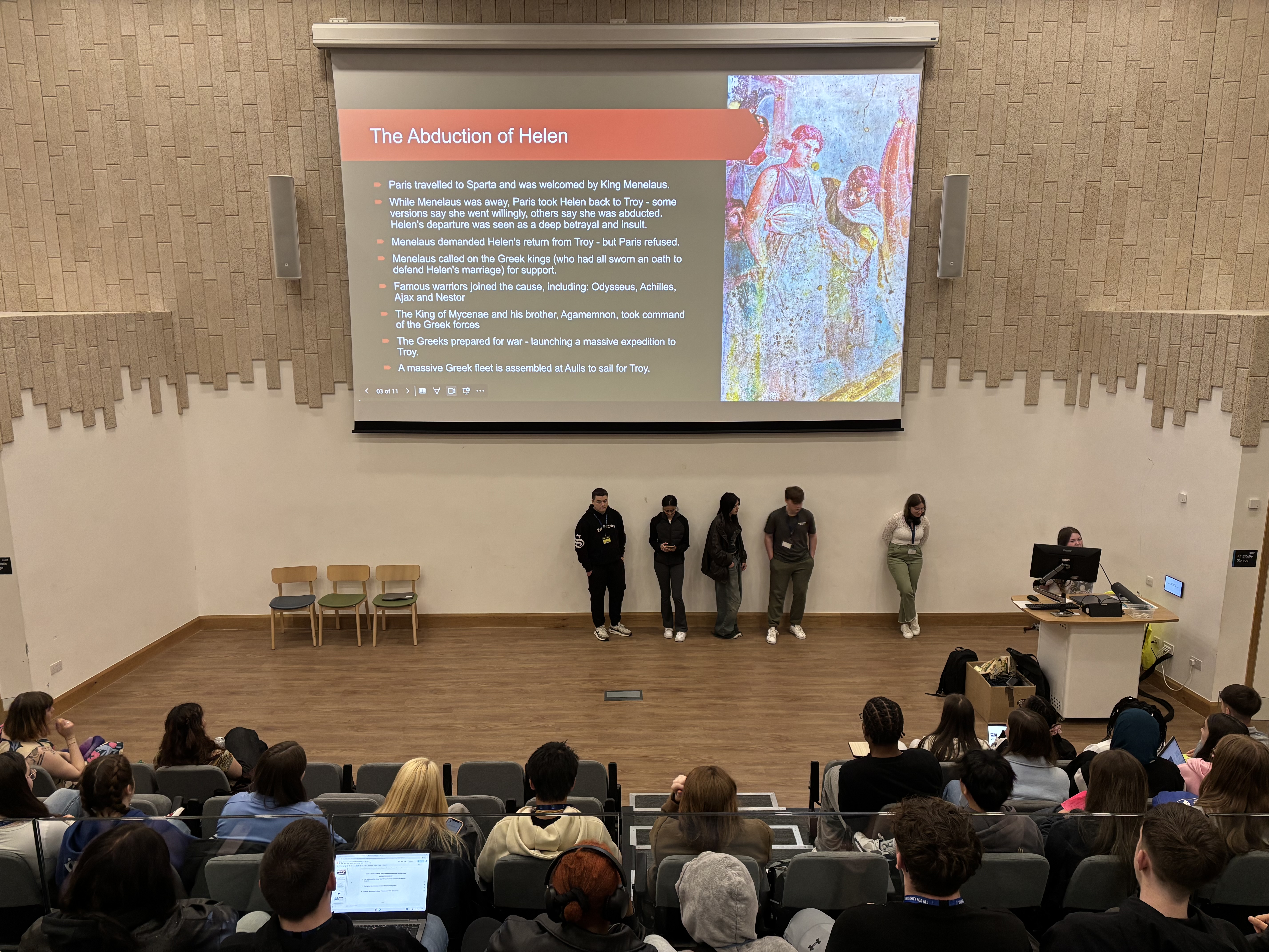 A group of students presenting their research project during the summer school