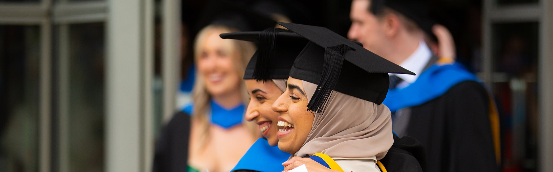 Friends hug each other as they graduate from UCD
