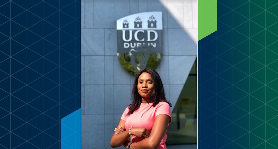 Chiamaka Onyinyechukwu Ofojimba stands in front of the UCD crest