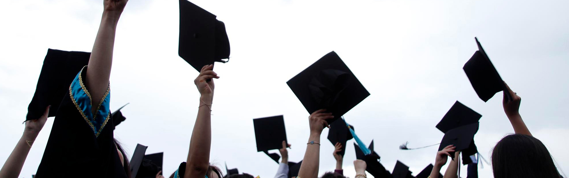 Graduation caps in the air