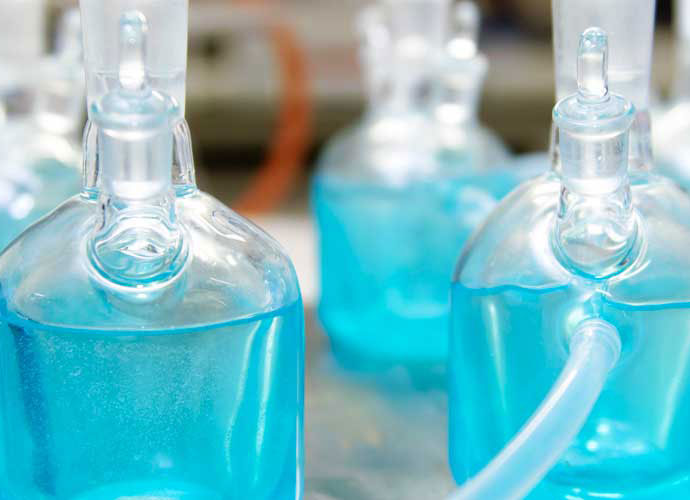 A collection of jars holding blue liquid