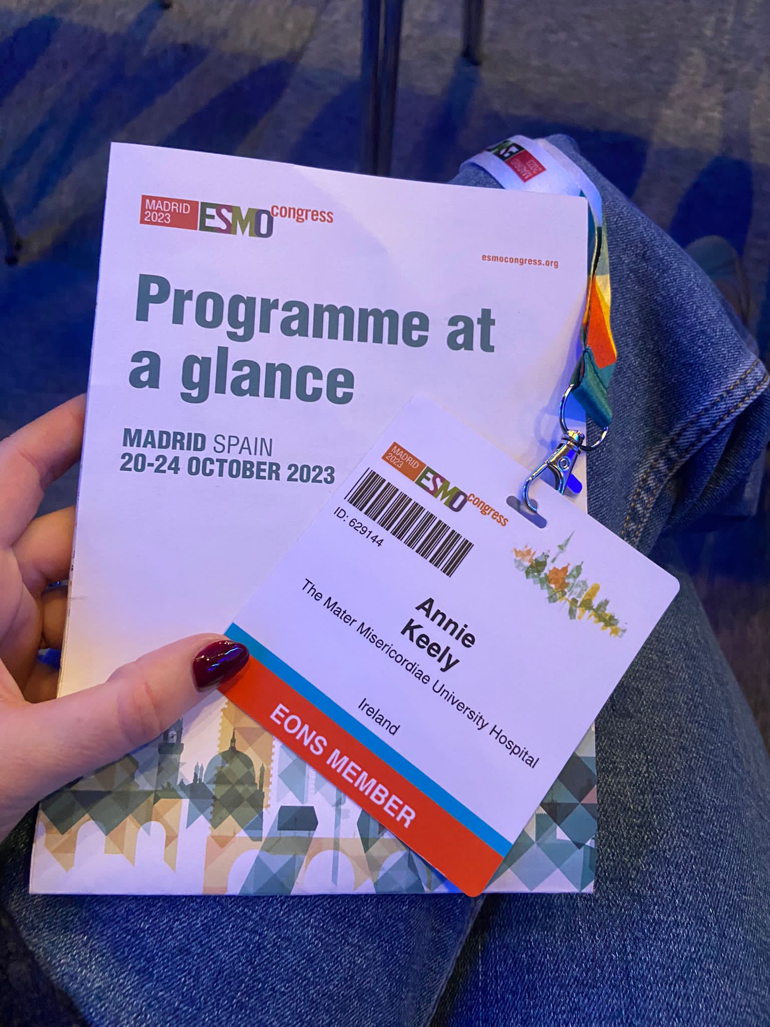A picture of the brochure and attendee badge for Annie Keely for the 2023 ESMO Congress