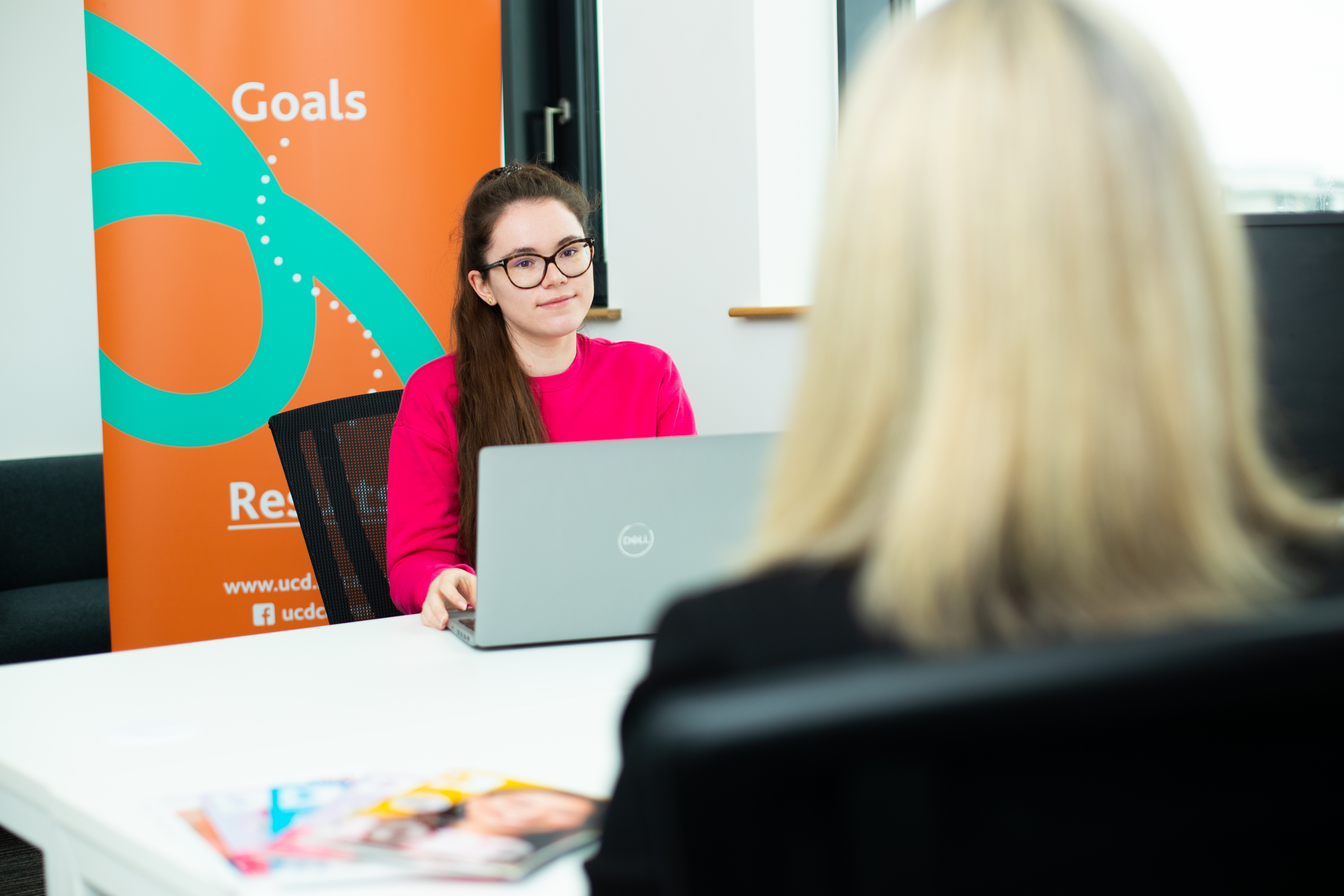 A student listening to a Career Consultant