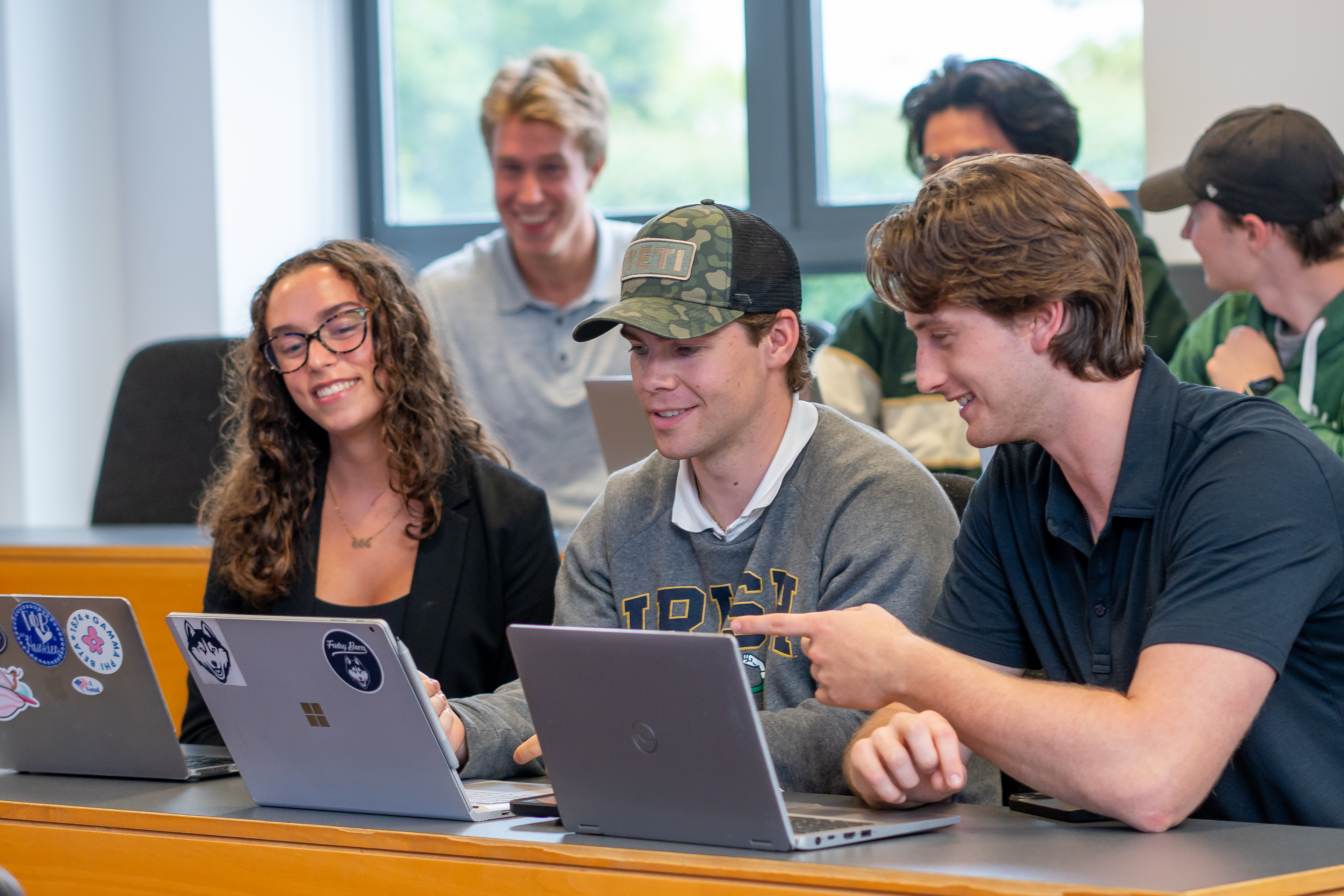 Students chatting in a lecture hall.