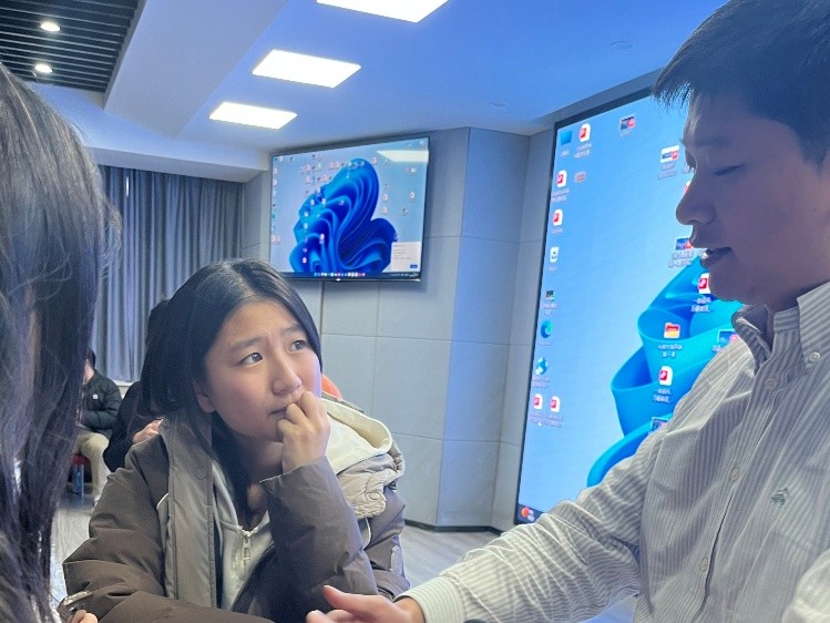 Group members engage with Dr. Shi after the lecture