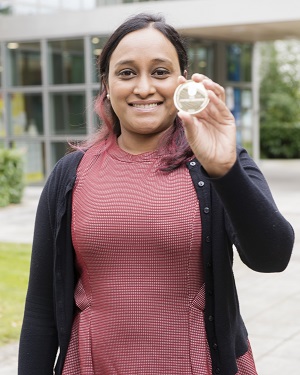 Woman holding gold medal prize