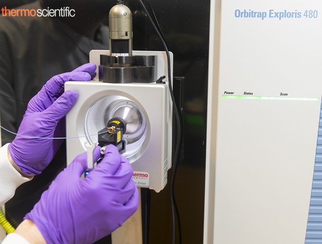 Gloved hands working a machine