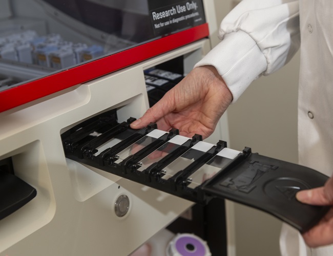 Hand guiding rack into machine