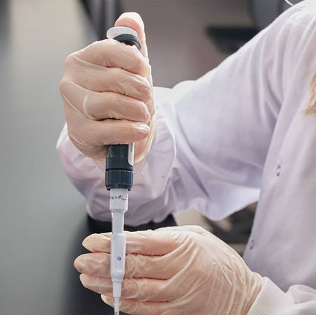 Laboratory instrument held in gloved hands