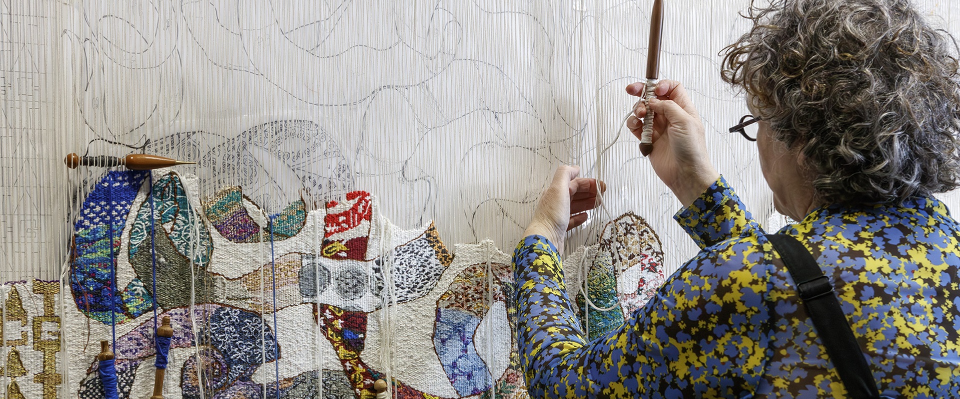 Woman weavng tapestry