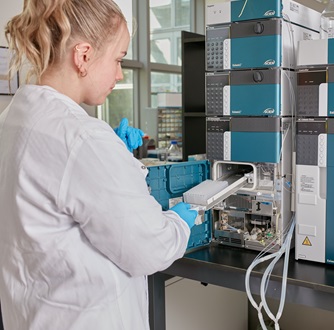 Woman standing at a machine