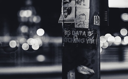 poster stating 'big data is watching you' on electrical pole on street