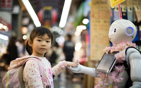 child holding hand of robot