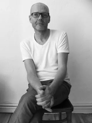 A black and white portrait of artist Mark Clare