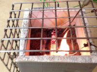 Ignited peat in a burn box