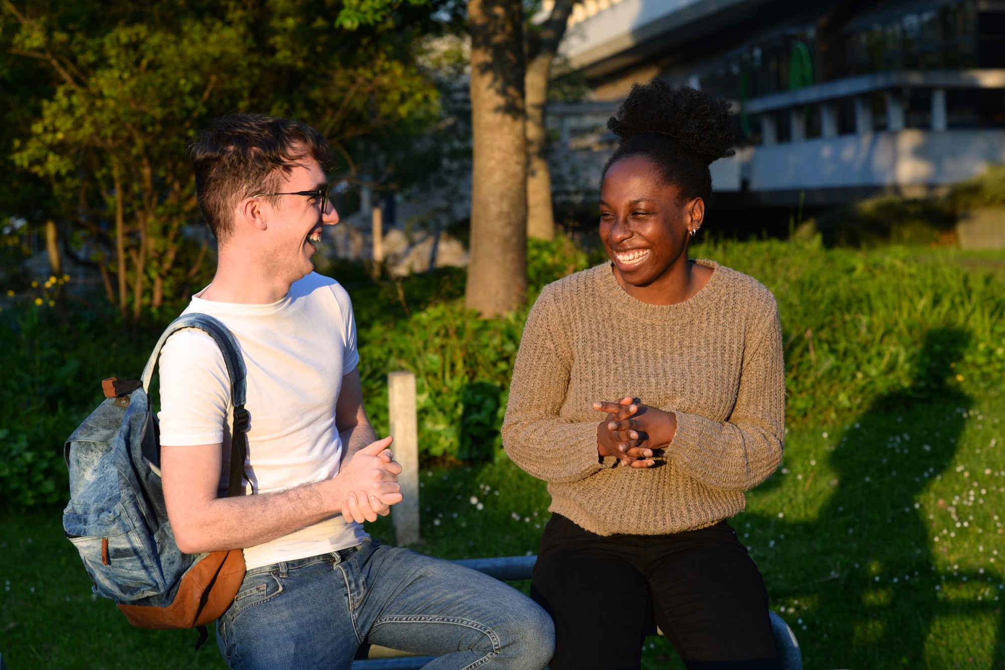 Two students laughing together on the UCD campus