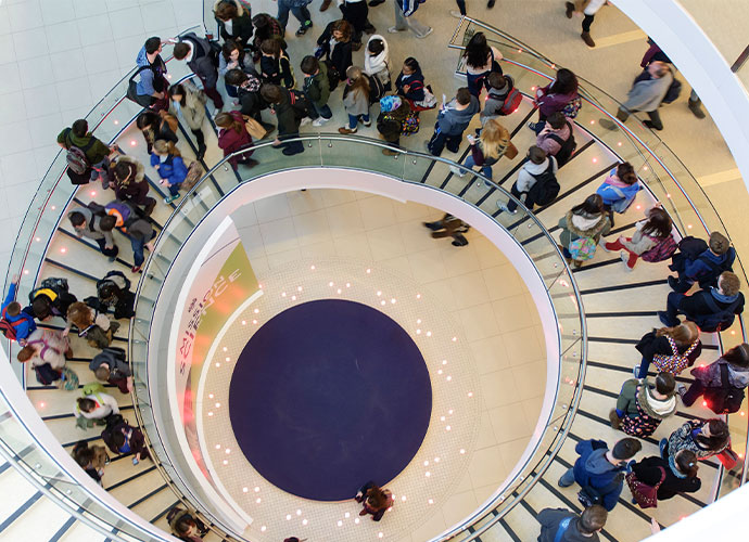 People walking on a white spiral staircase.