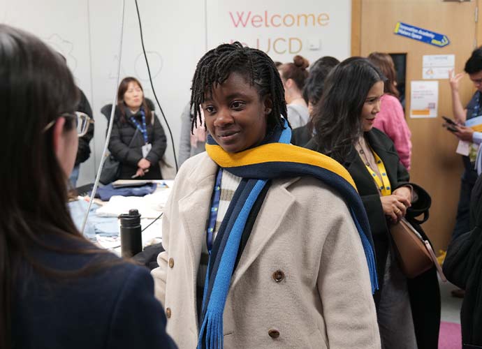 Two women stand chatting at a counsellor visit on UCD campus.