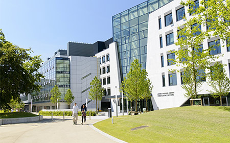 Two students walking outside the UCD Science Building.