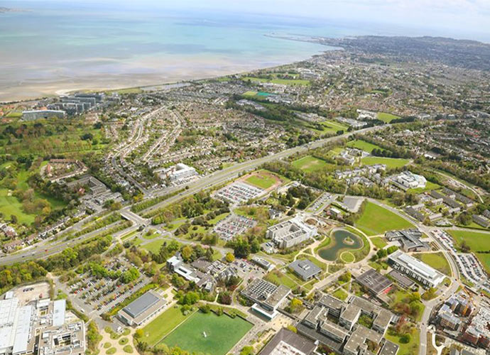 Aerial shot of UCD campus with the sea in the background.