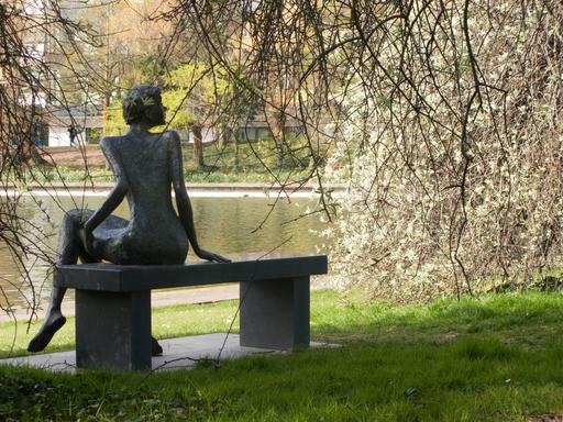 Statue by lake