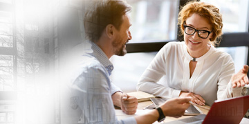 Image of two staff talking