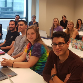 Gaeltacht UCD students sitting at desks looking at the camera