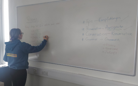 Language ambassador writing on whiteboard