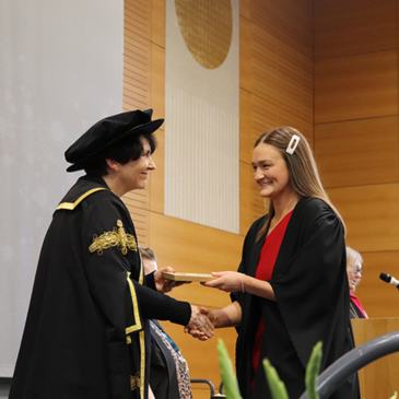 Prof Orla Feely handing diploma to Aoibh McIntyre at Medicine Graduation