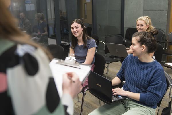 Students sitting in classroom smiling