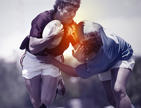 Two men clash in a game of rugby. One man has a glowing red shoulder to indicate pain.