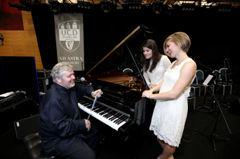 Bill whelan, who was awarded the UCD Foundation Day Medal pictured with UCD Choral Scholars Susan Gibbons and Megan O'Neill