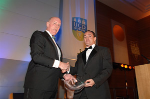 Photo of Brian Mullins, Director UCD Sport presenting Brian Dooher, Tyrone Football Captain with UCD Award for Outstanding Achievements in 2005 