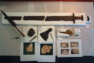 Viking weaponry find following conservation at UCD School of Archaeology including a full sword, a shield boss, a spear head, a wooden handled knife, a bronze cloak pin and a sharpening stone