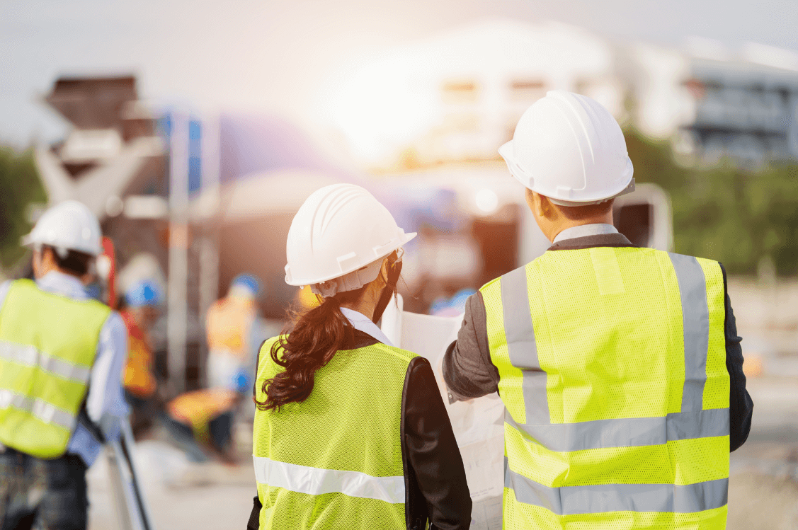 Health and safety workers in high-vis vests and hard hats