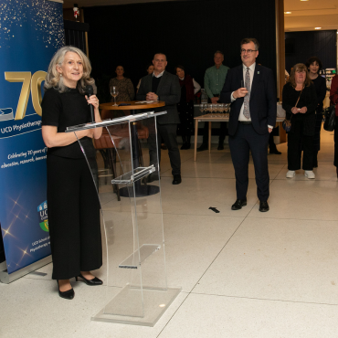 Woman in a black outfit speaking at the UCD Physiotherapy 70th anniversary celebration
