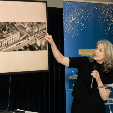 Woman in a black outfit speaking at the UCD Physiotherapy 70th anniversary celebration