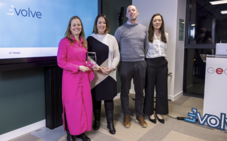 Group of three women and one man with an award