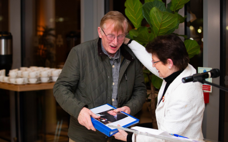 Professor Patrick Wall receiving a folder from Associate Professor Mary Codd